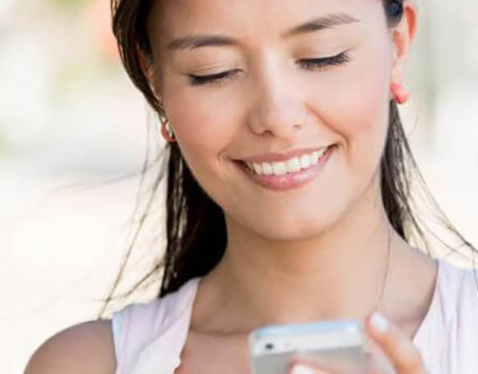 Smiling woman on her cellphone